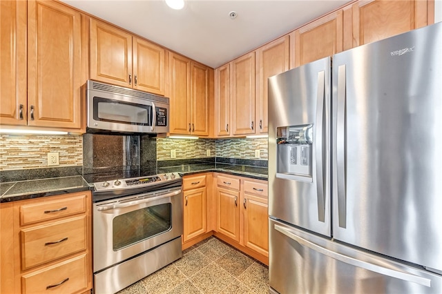 kitchen featuring stainless steel appliances, tasteful backsplash, and light tile floors