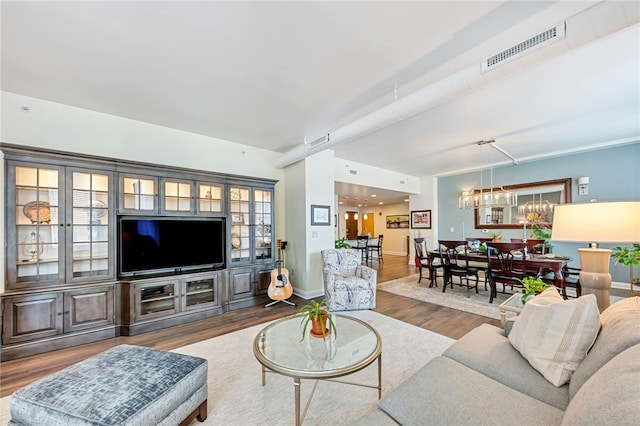 living room featuring dark hardwood / wood-style floors and an inviting chandelier