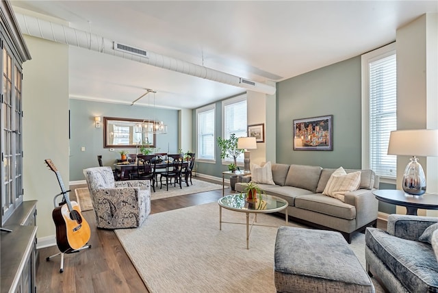 living room with a chandelier and wood-type flooring