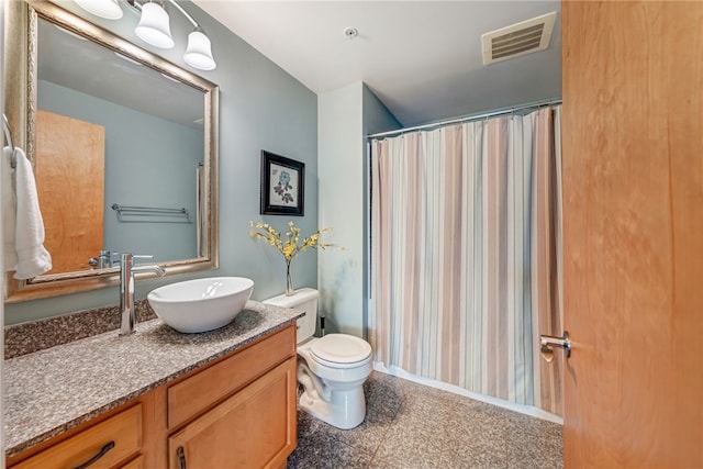 bathroom featuring tile flooring, toilet, and vanity