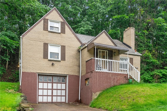 view of front of home with a front lawn and a garage