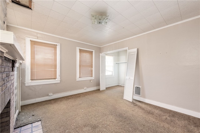 unfurnished living room featuring carpet and ornamental molding