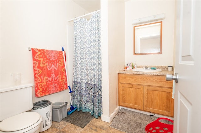 bathroom with tile floors, toilet, and vanity