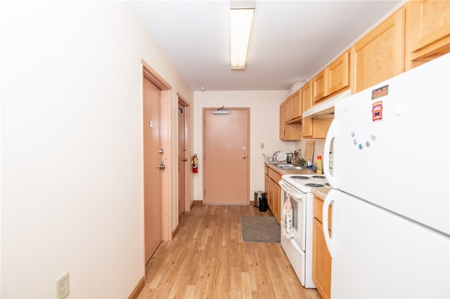 kitchen with light brown cabinets, sink, white appliances, and light wood-type flooring