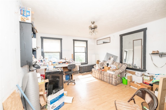 living room featuring radiator heating unit and hardwood / wood-style floors