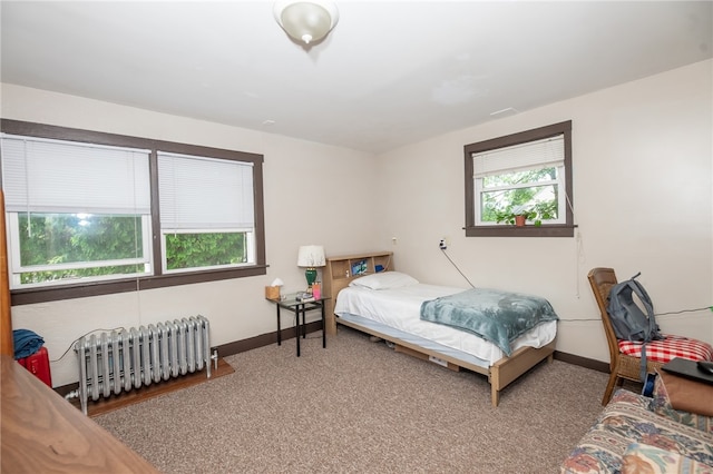 bedroom featuring carpet and radiator heating unit