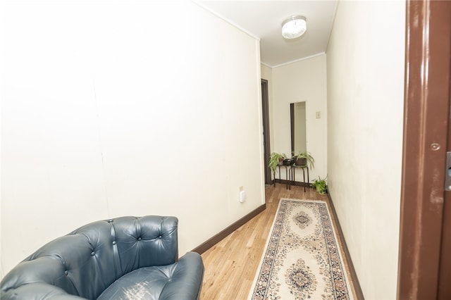 hallway featuring hardwood / wood-style floors and ornamental molding