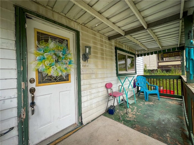 view of exterior entry featuring a porch