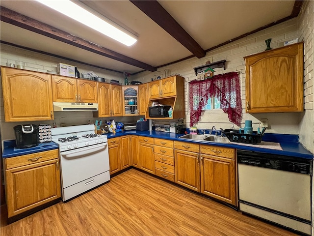 kitchen featuring beamed ceiling, white appliances, sink, and light wood-type flooring