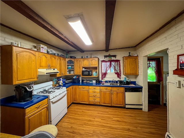 kitchen with brick wall, beam ceiling, white appliances, and light wood-type flooring