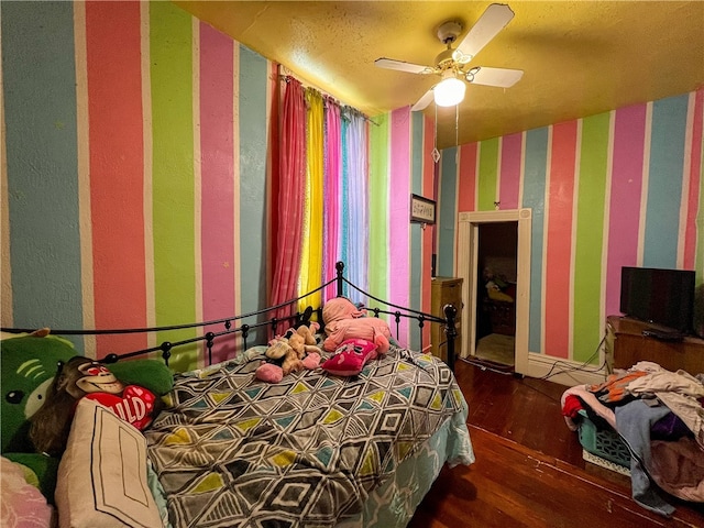 bedroom with wood-type flooring and ceiling fan