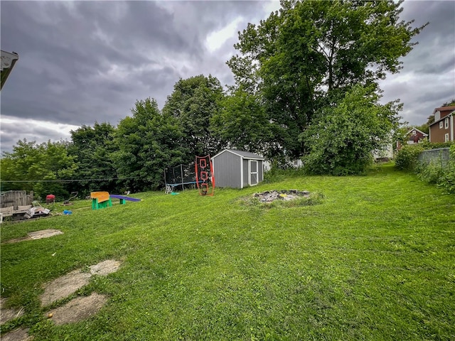 view of yard with a shed and a trampoline