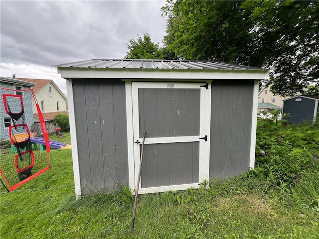 view of outdoor structure with a lawn