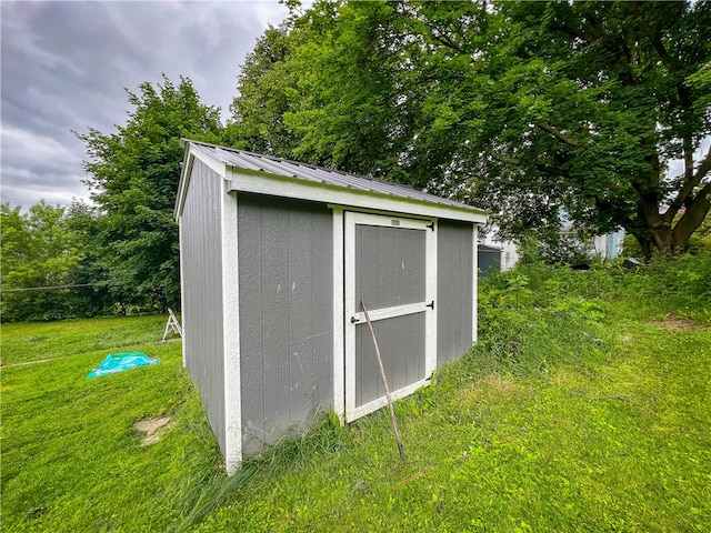 view of outdoor structure with a lawn