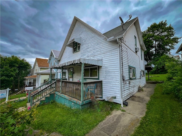 back of property featuring a lawn