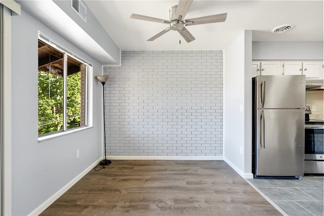 unfurnished dining area with hardwood / wood-style floors and ceiling fan