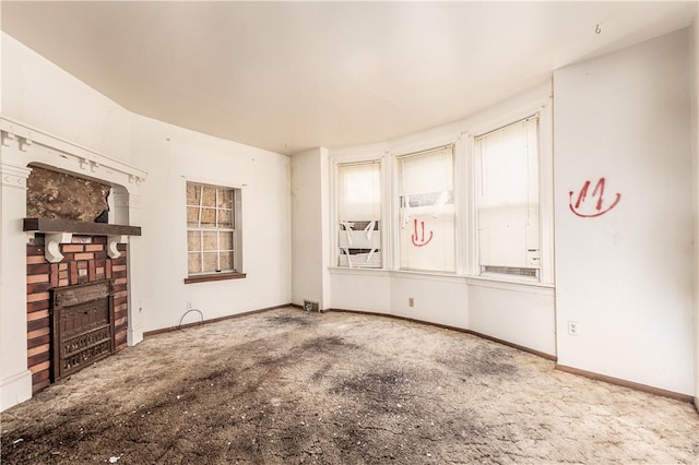 unfurnished living room with carpet and a fireplace