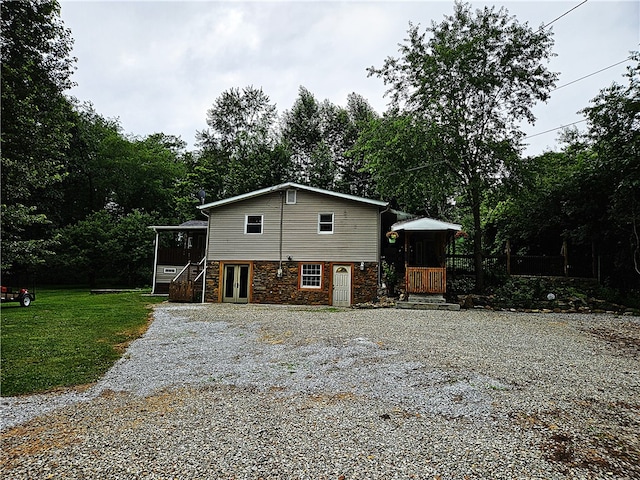 rear view of property with a yard