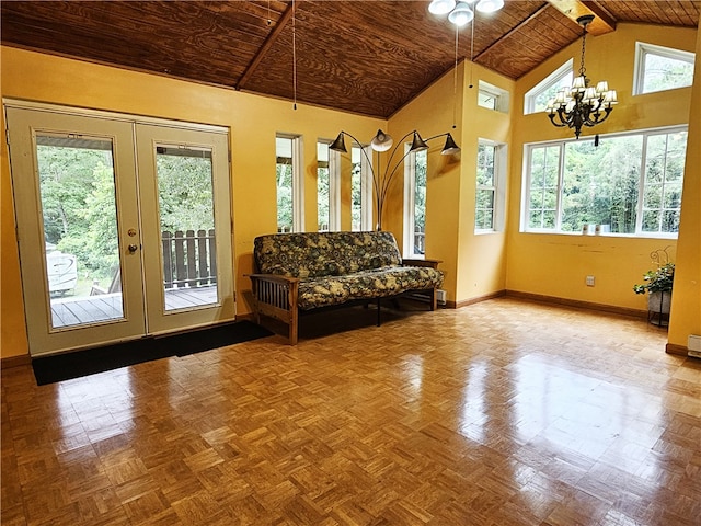 interior space featuring a notable chandelier, vaulted ceiling, plenty of natural light, and wooden ceiling