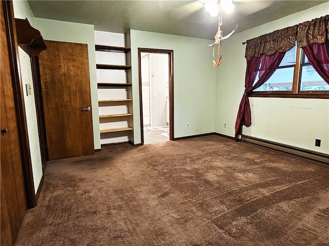 unfurnished bedroom with a baseboard heating unit, carpet, and ceiling fan