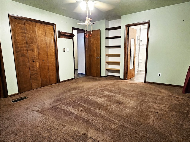 unfurnished bedroom featuring ensuite bathroom, carpet, and ceiling fan