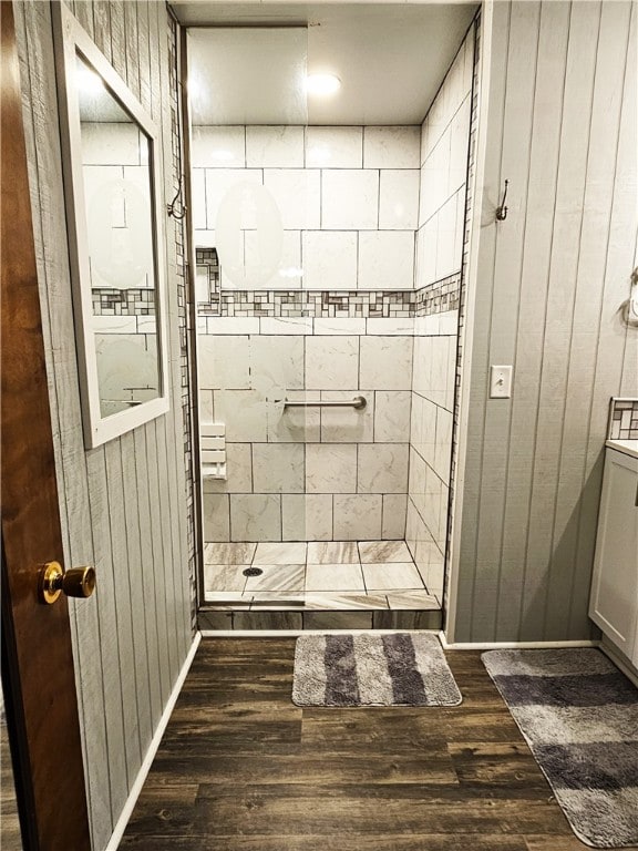 bathroom featuring a tile shower and hardwood / wood-style flooring