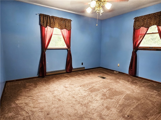 carpeted spare room with a baseboard heating unit, ceiling fan, and a textured ceiling