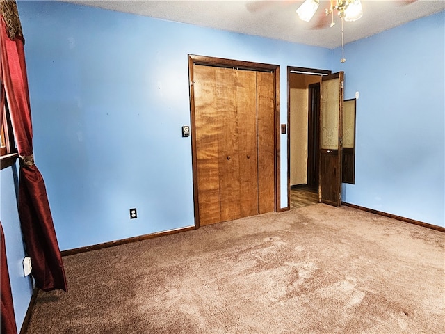 unfurnished bedroom with carpet flooring, a closet, and ceiling fan