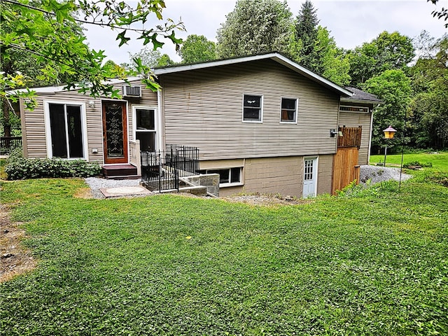 rear view of house featuring a yard