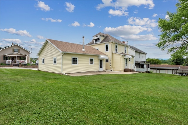 rear view of property with a lawn