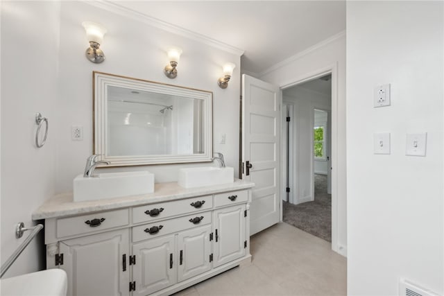 bathroom featuring tile floors, ornamental molding, and vanity