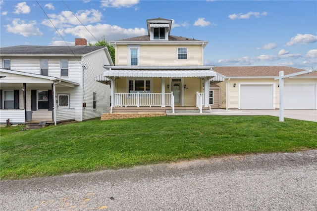 view of front of property with a garage, a front yard, and covered porch