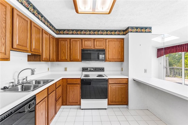 kitchen with light tile patterned flooring, a skylight, sink, black appliances, and a textured ceiling