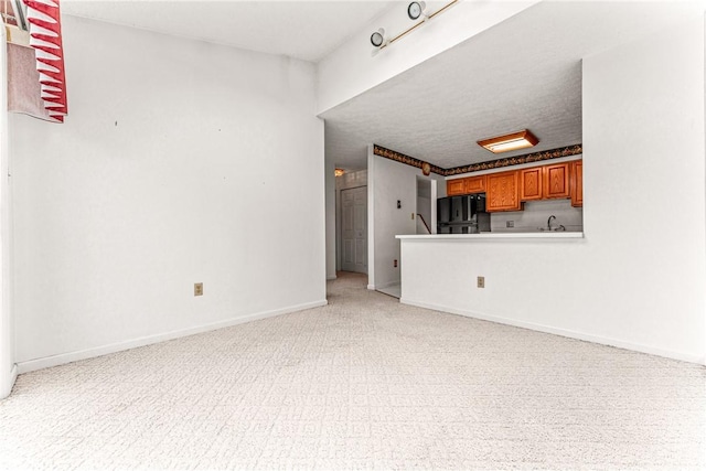 unfurnished living room with sink