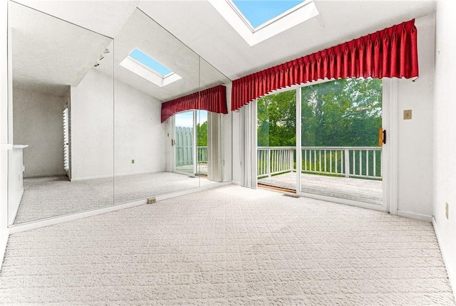 carpeted empty room featuring vaulted ceiling