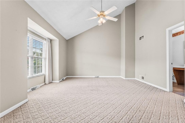 empty room featuring lofted ceiling, carpet, and ceiling fan