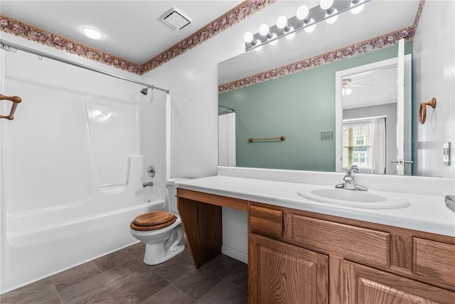 full bathroom featuring vanity, bathtub / shower combination, and toilet