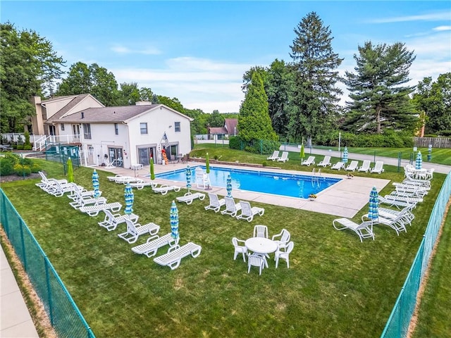 view of pool with a yard and a patio