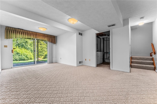 interior space with a textured ceiling and light carpet