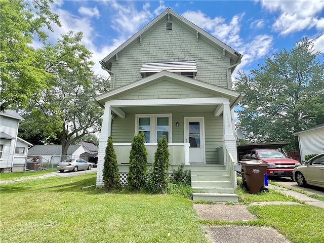 view of front facade with a porch and a front lawn