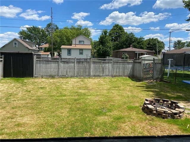 view of yard with a shed and a trampoline