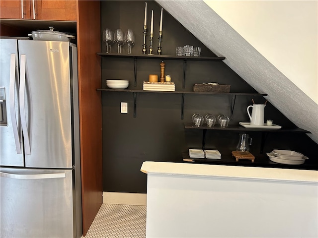 bar featuring stainless steel fridge and light tile flooring