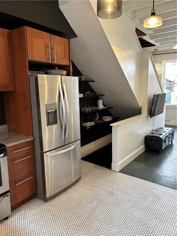 kitchen featuring range, stainless steel fridge, pendant lighting, and light tile floors