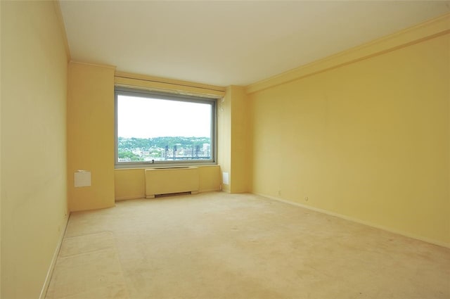 unfurnished room with crown molding and radiator heating unit