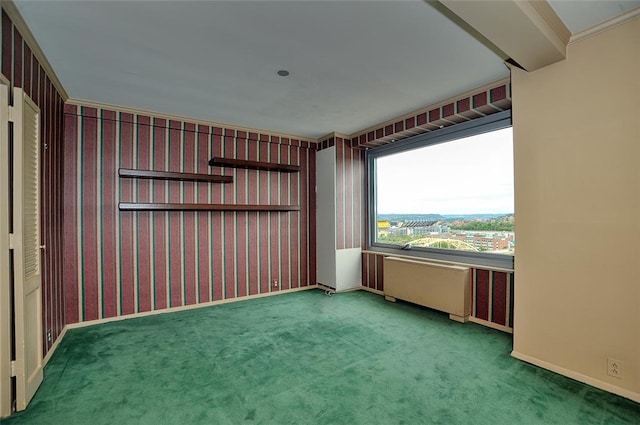 carpeted empty room with ornamental molding and radiator