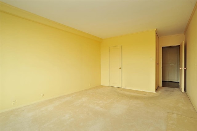 unfurnished bedroom featuring a closet, carpet, and ornamental molding