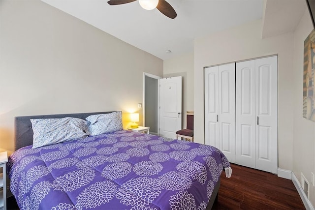 bedroom with a closet, ceiling fan, and dark hardwood / wood-style floors