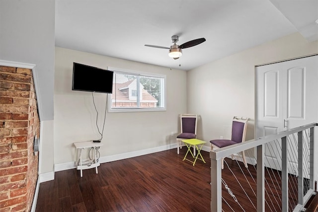 living area featuring wood-type flooring and ceiling fan