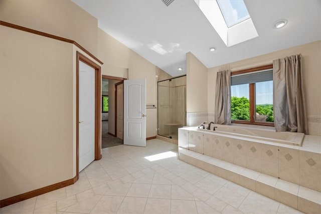 bathroom with tile patterned floors, vaulted ceiling with skylight, and shower with separate bathtub