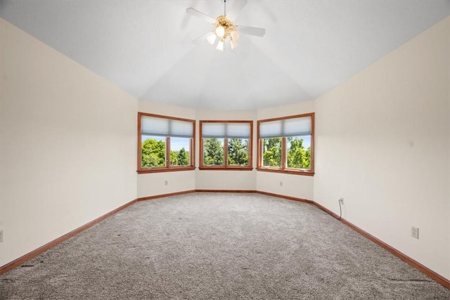 unfurnished room with a wealth of natural light, carpet floors, and lofted ceiling